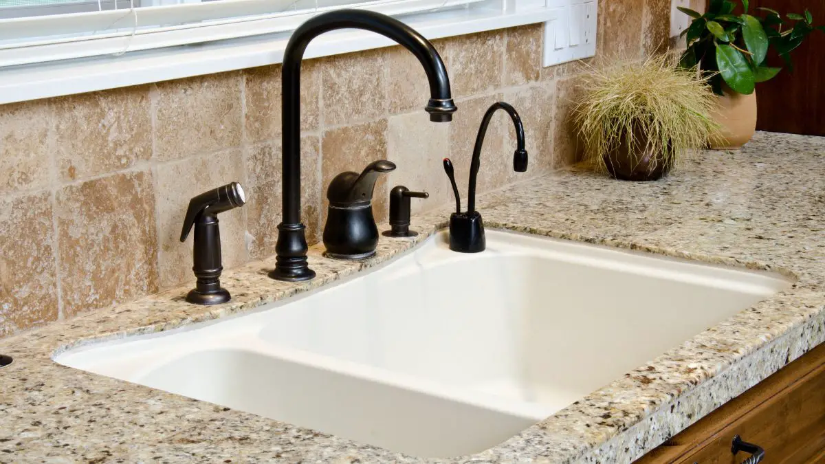 Close up kitchen sink with granite counter